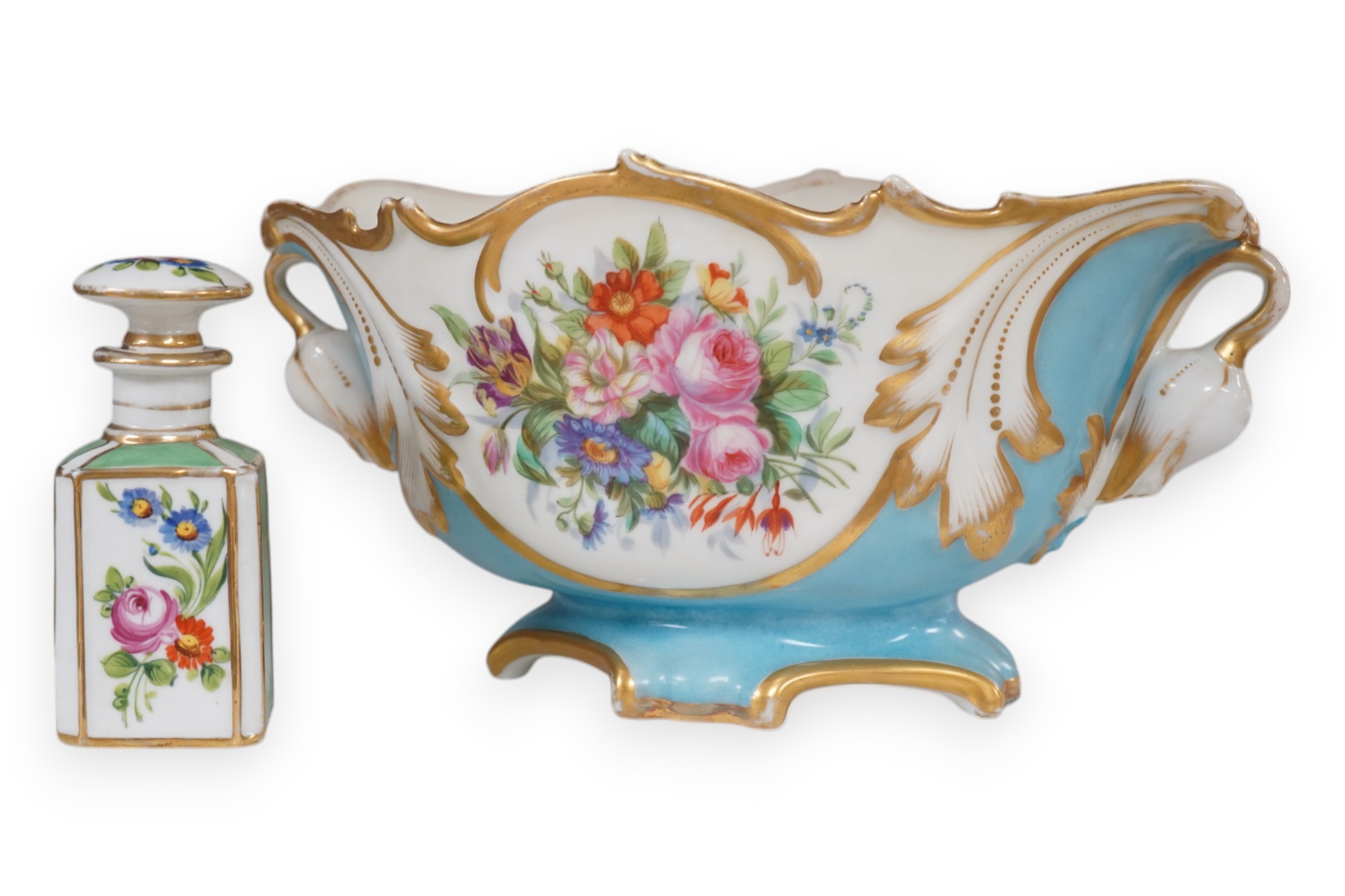 A Sevres style flower painted navette shaped jardiniere and a similar French scent bottle and stopper, late 19th century, largest 38cm wide. Condition - fair to good